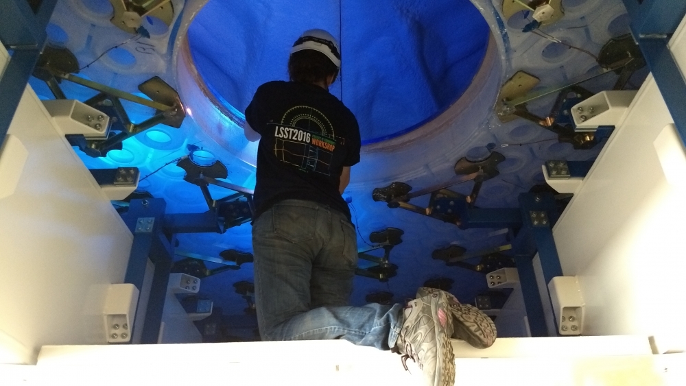 Telescope & Site Optics Engineer Constanza Araujo inspects the top surface of the mirror